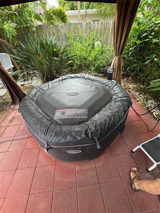 Inflatable hot tub under a pergola