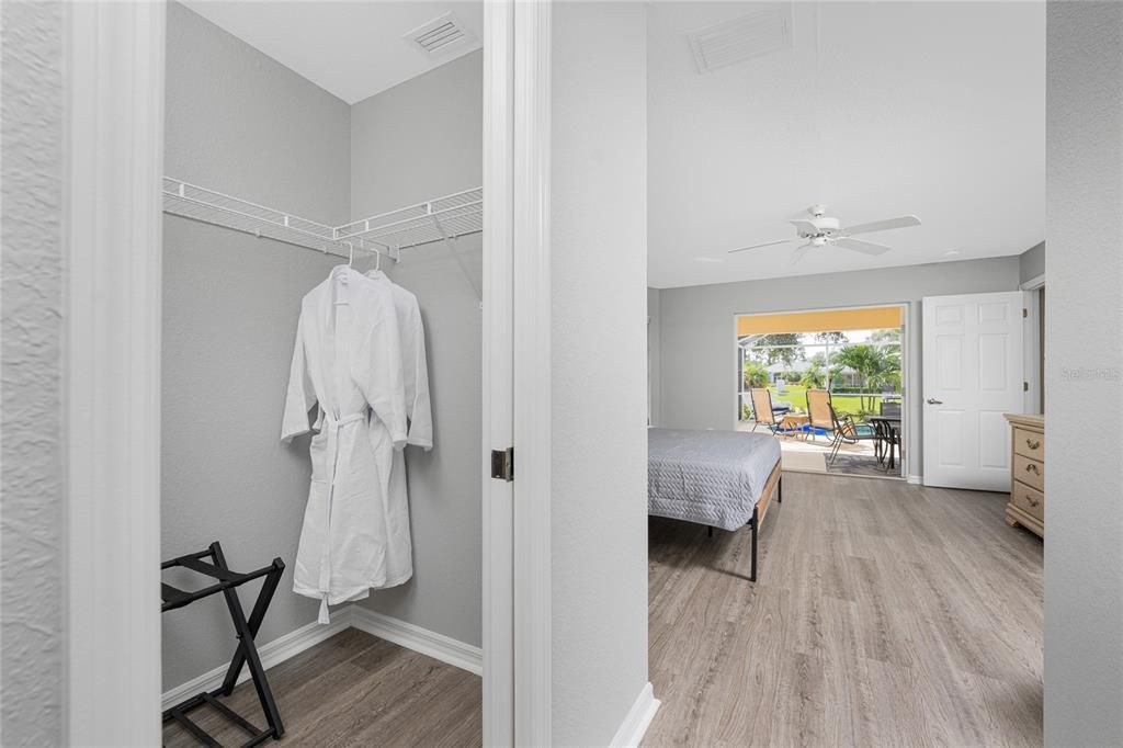 Closet with Suitcase Rack and Bathrobes