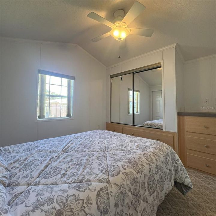 Bedroom with built in dresser and closet