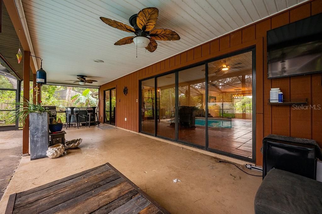 The massive lanai gives you space for outdoor living and dining all overlooking the SCREENED POOL and large FENCED BACKYARD where the landscaping adds privacy and tranquility in this park-like setting.