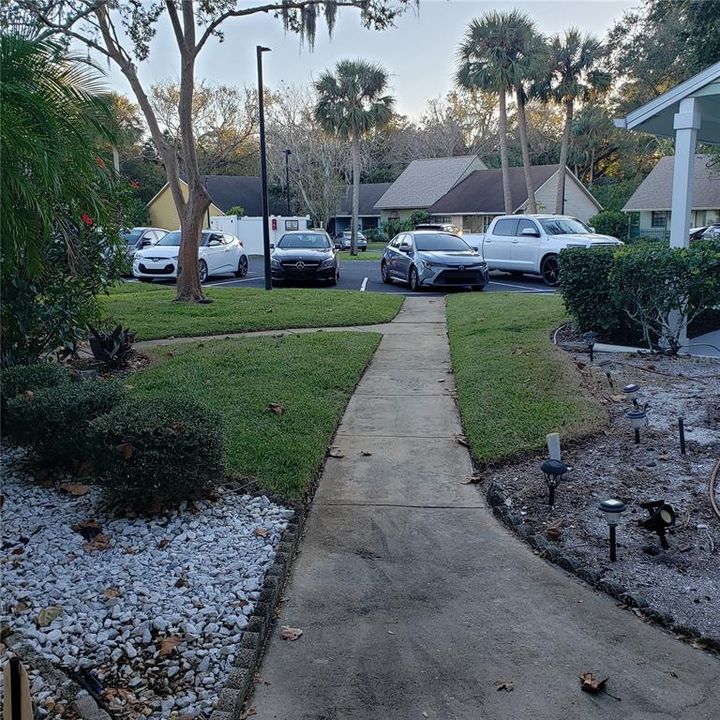 walkway from front door to parking spot with guest spots behind