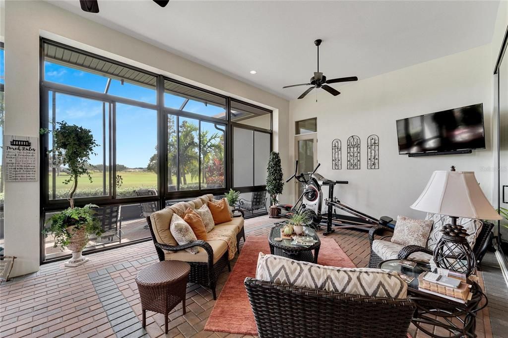 Large Covered Porch with beautiful brick pavers, lots of room for entertaining, working out, screened in windows and a summer kitchen with room for dining.