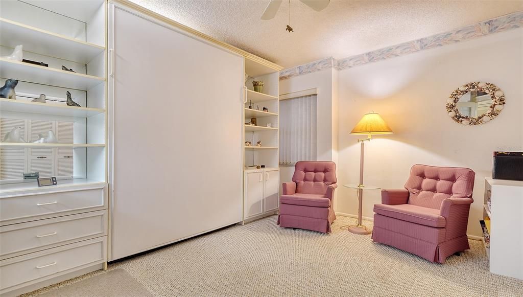 Guest bedroom features a SICO wall bed and built-ins.