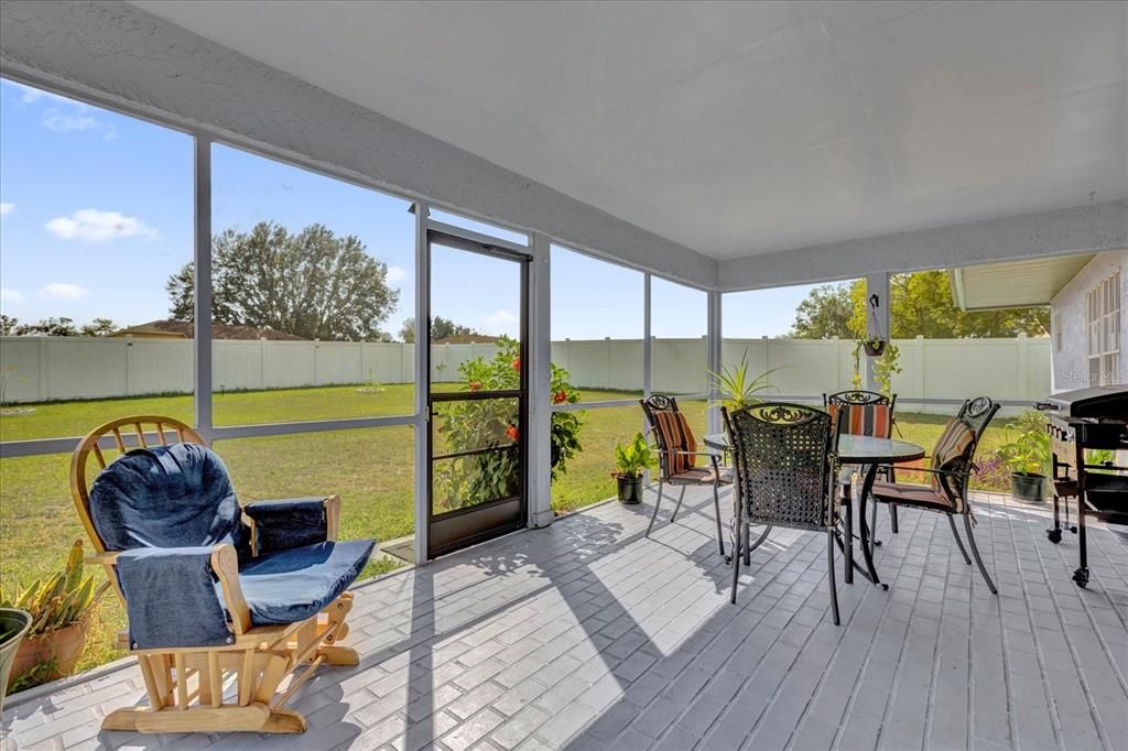 Enjoy the beautiful weather & views of the oversized yard in this enlarged Screened-in Patio