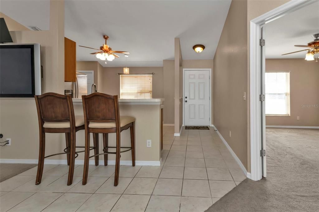 Breakfast bar in kitchen with tile flooring