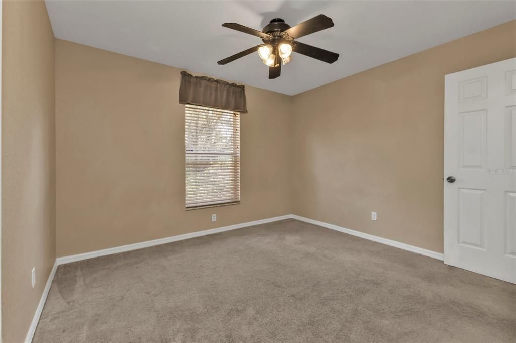 3rd guest bedroom with carpet flooring