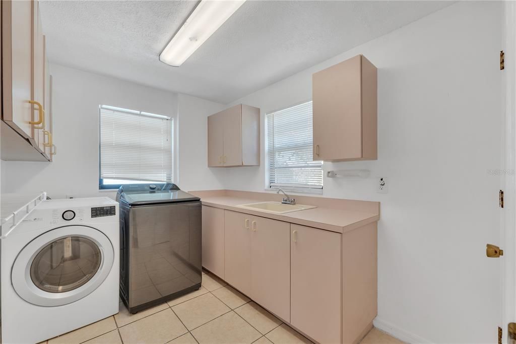 A generous utility room with a sink offers versatile options for a craft space or home office.