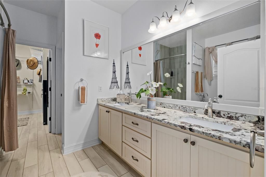 Master bath with new wooden vanities, granite counters