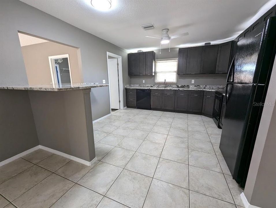 Entertainment counter top with pass through to family room and door to laundry room