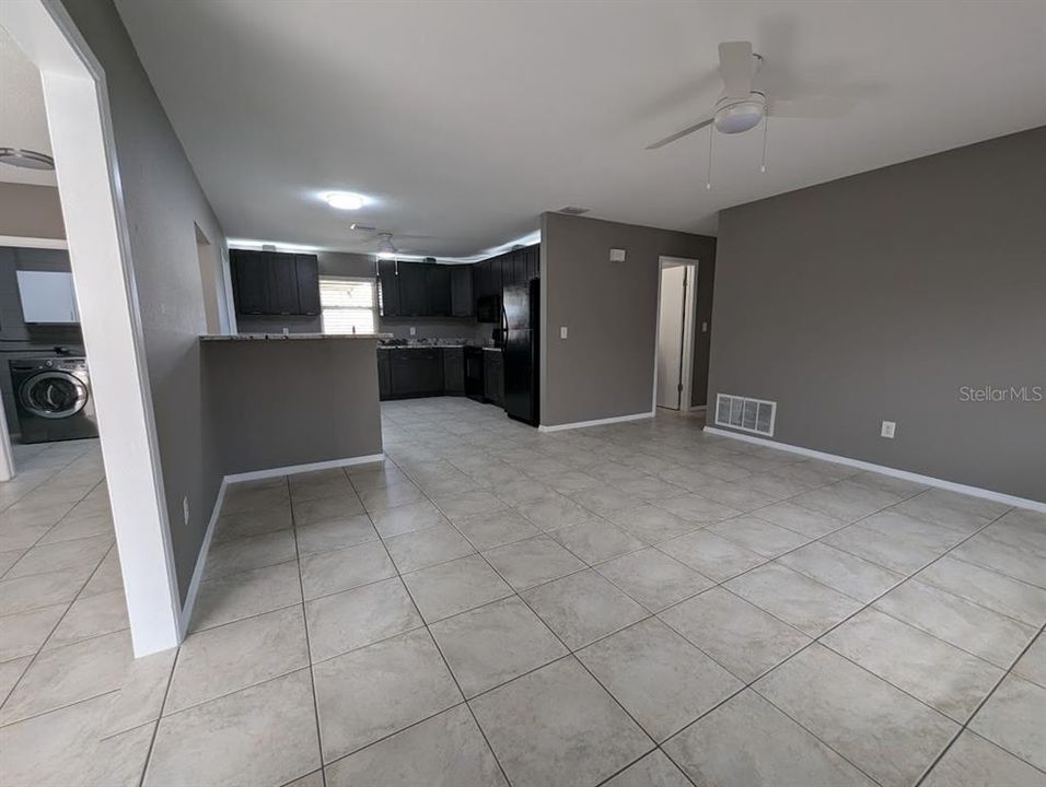 View from entry with living room, kitchen and family room