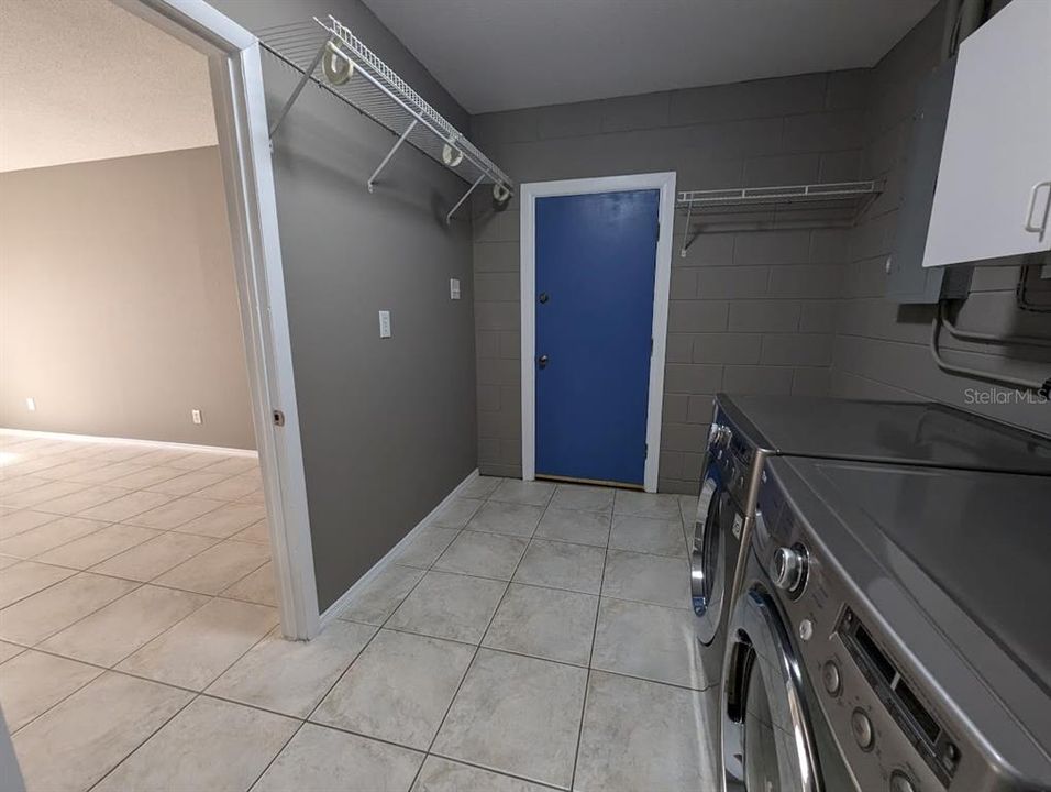 Laundry room with doorway to family room and exit door to back yard