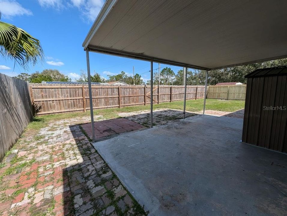 Fully fenced backyard with covered patio and lockable storage