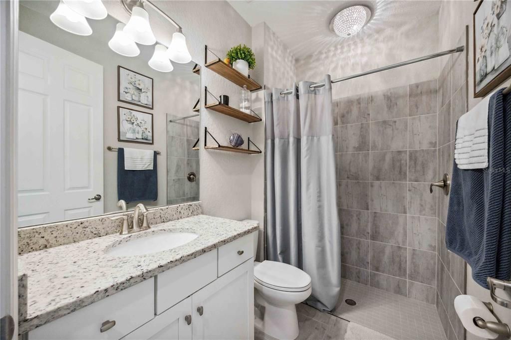 Guest Bathroom with Walk In Shower and Chandelier