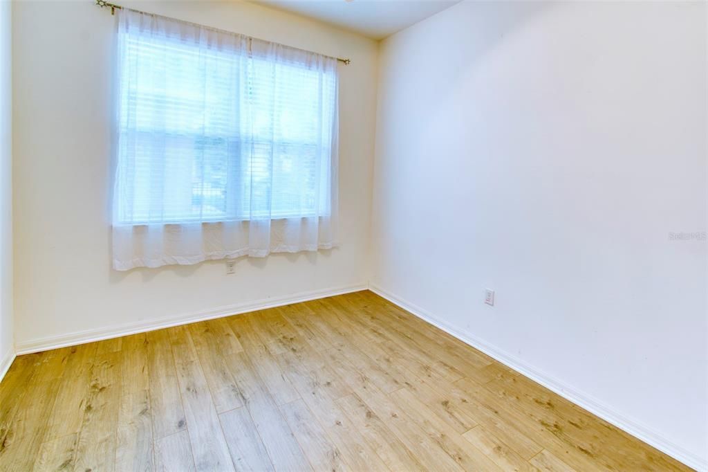 The guest bedroom is separate for privacy - laminate flooring here too!