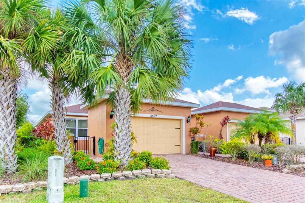 The landscaped 2/2 villa is nestled among palms and pines!