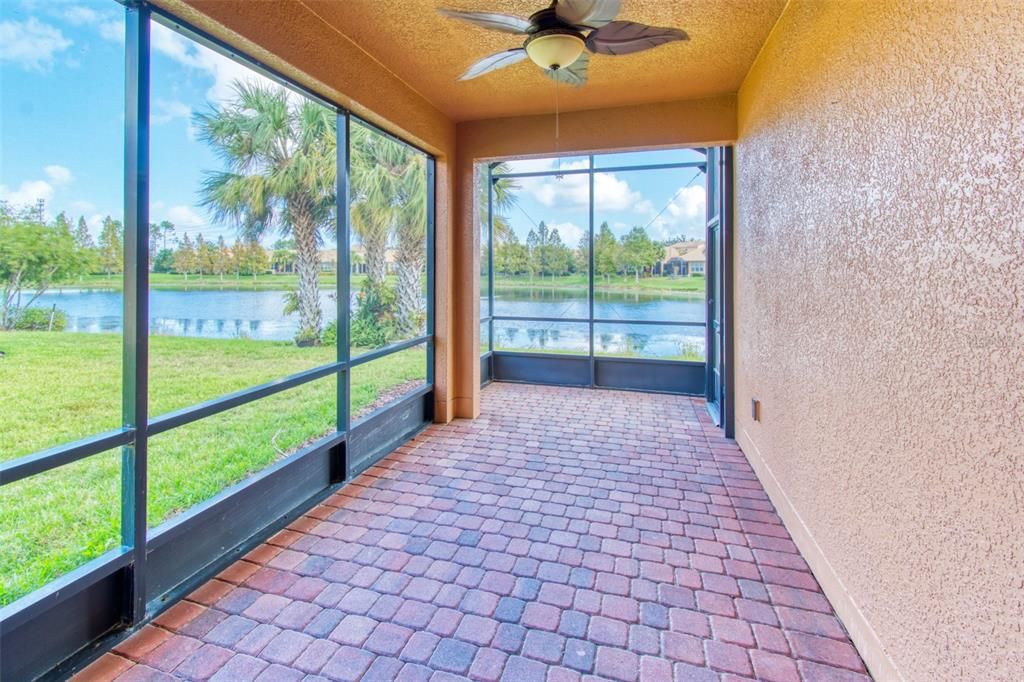 Step out through the sliders to true Florida living - this wonderful covered lanai is full screened with views out to the pond and greenspace