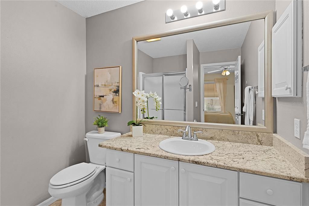 The en-suite bathroom features a walk-in shower and GRANITE countertops.