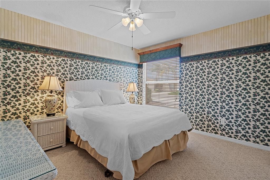 The guest bedroom offers double-door closets and a welcoming space for visitors.