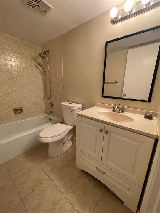 updated vanity, sink and faucet, cast iron tub, new toilet, Spa showerhead with Handheld shower.