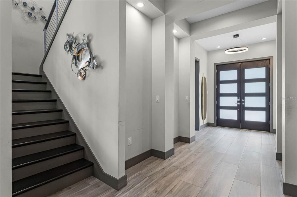 Grand Entrance: Step through these grand double 8' doors and into a world of sophisticated design. The gallery wall entrance is the perfect place to showcase your favorite art pieces.