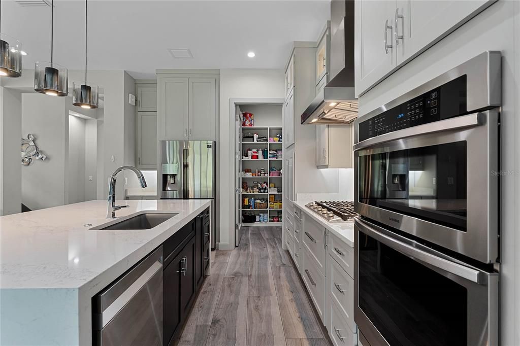 Modern Kitchen: The heart of this home is a chef’s dream! A spacious 9' x 4' island, 5-burner gas cooktop with pot filler, and floor-to-ceiling cabinetry make this gourmet kitchen as functional as it is stylish.