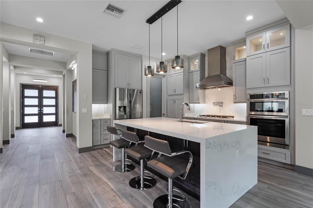 Modern Kitchen: The heart of this home is a chef’s dream! A spacious 9' x 4' island, 5-burner gas cooktop with pot filler, and floor-to-ceiling cabinetry make this gourmet kitchen as functional as it is stylish.