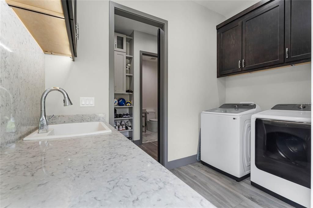 Laundry Room:Laundry day made luxurious! This bright laundry room features large windows for natural light and custom-built California closets for extra storage and organization, making it as functional as it is beautiful.