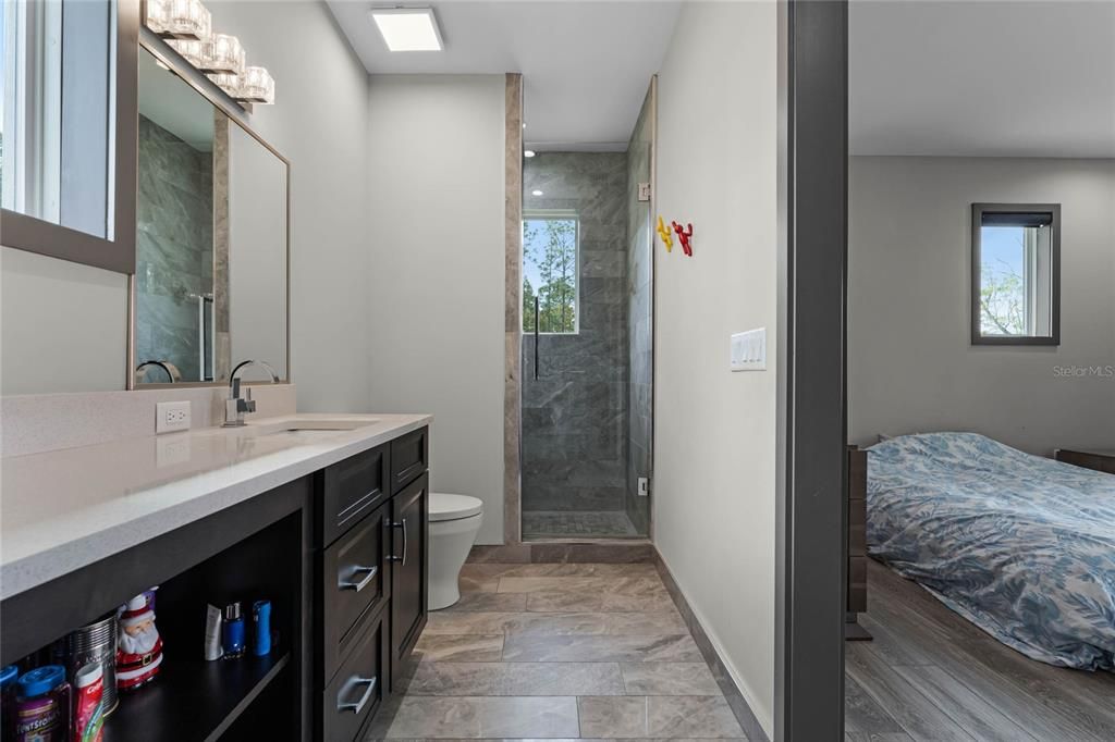 A private retreat! Bedroom 4 features its own ensuite bathroom with sleek modern finishes, offering convenience and privacy for guests or family members.