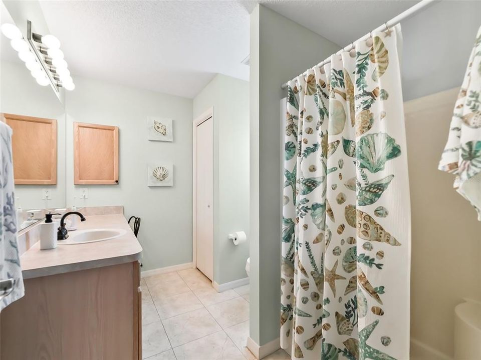 Walk-In Shower. Bath has a window providing Natural Florida Sunshine