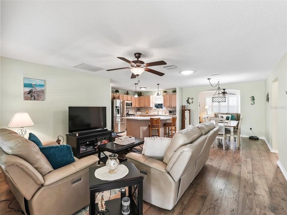 View from the Front Door.  Laminate Flooring throughout the home with the exception of the Kitchen/Baths