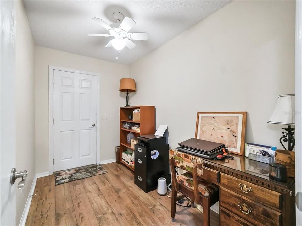 Spacious Home Office with Door Leading to the Two Car Garage