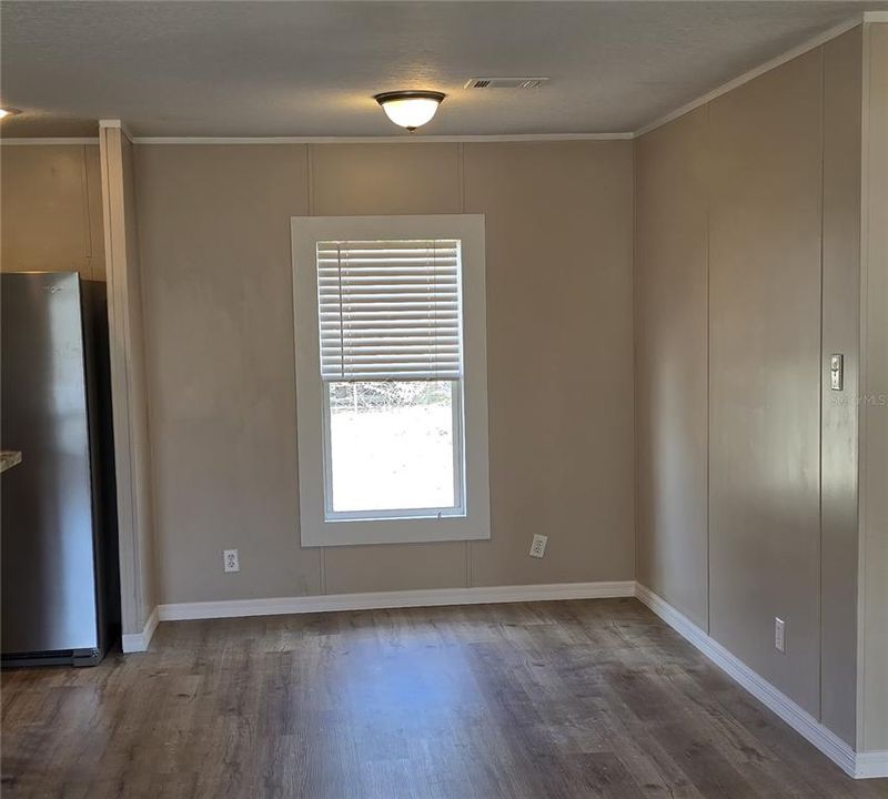 Off the opposite side of the kitchen is the large laundry room, which can also be utilized as a mud room as it houses the backdoor to the home.