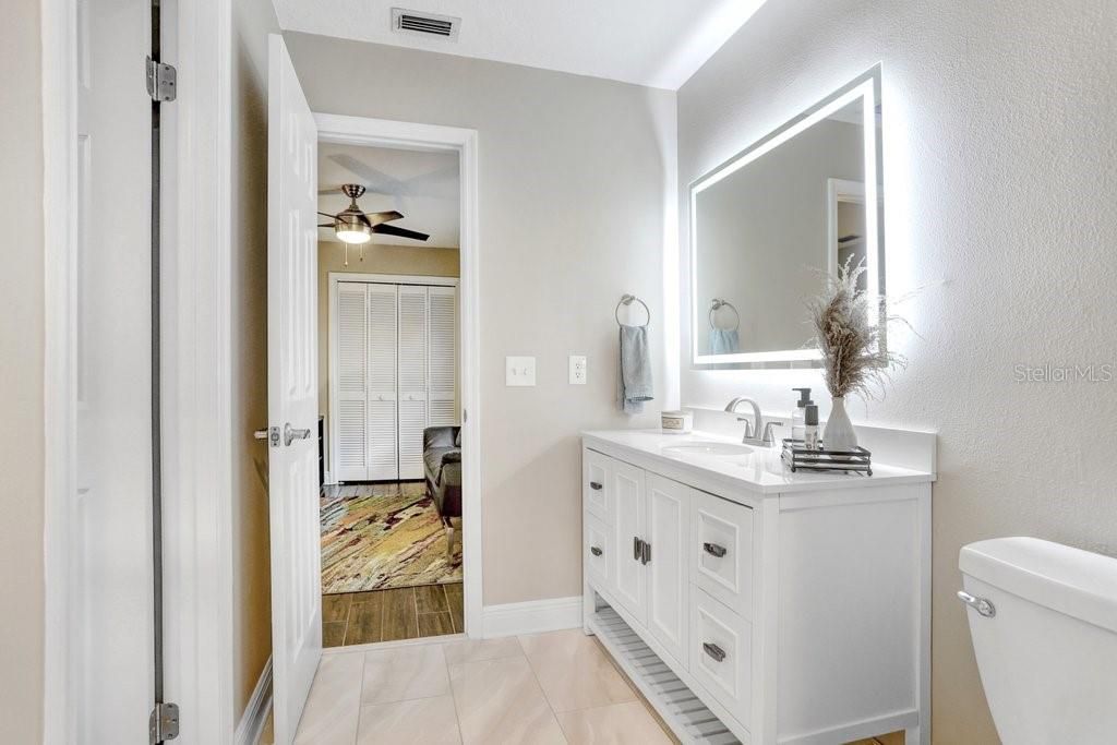 The Jack-n-Jill bathroom is completely updated and has a door to the pool and patio!