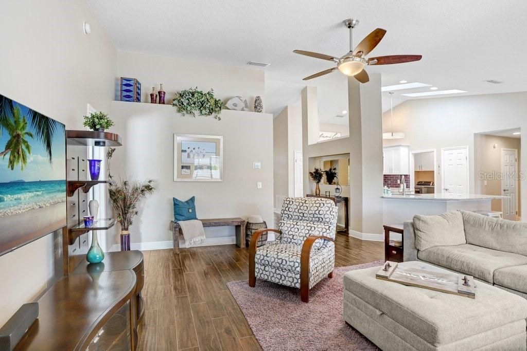 Main great room! There is ceramic plank tile flooring.....5-3/4 baseboards.....and high ceilings EVERYWHERE in the home!