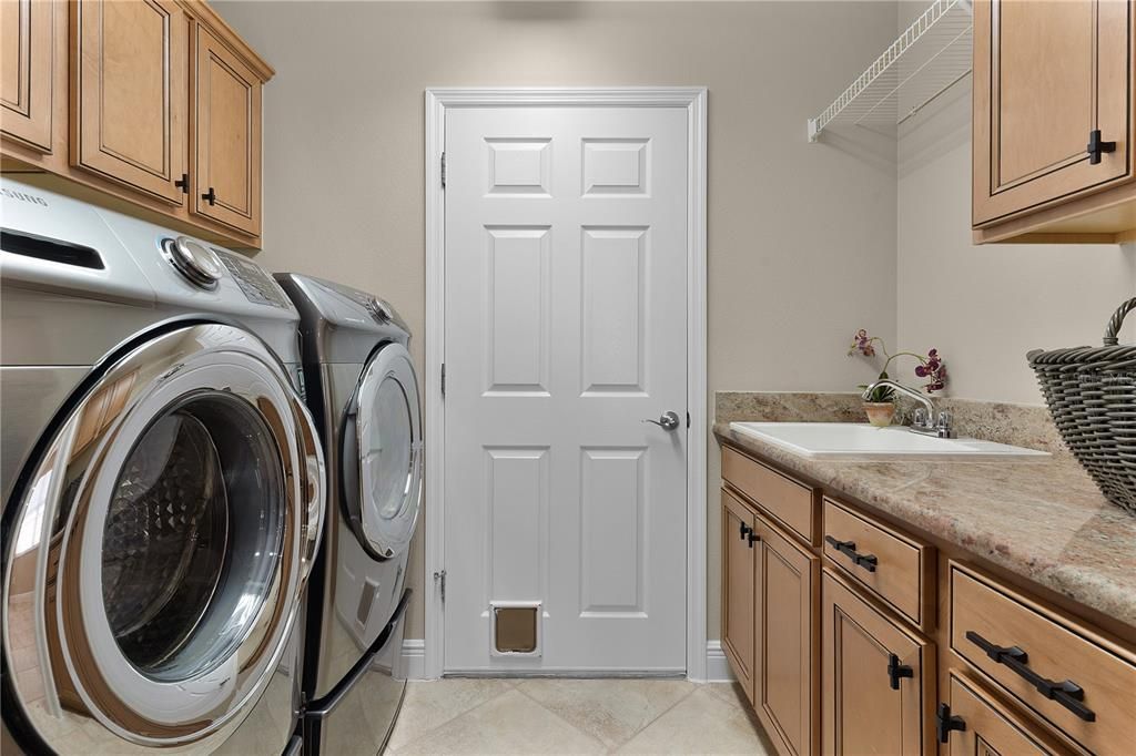 Laundry room with GRANITE counter folding station & large sink.