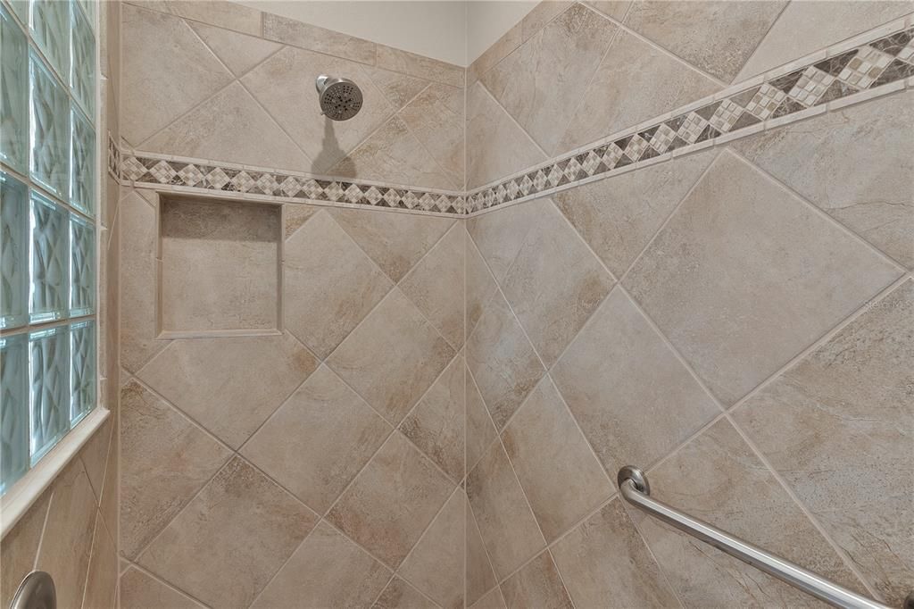 Roman Shower with block glass, tile inlay & shower seat