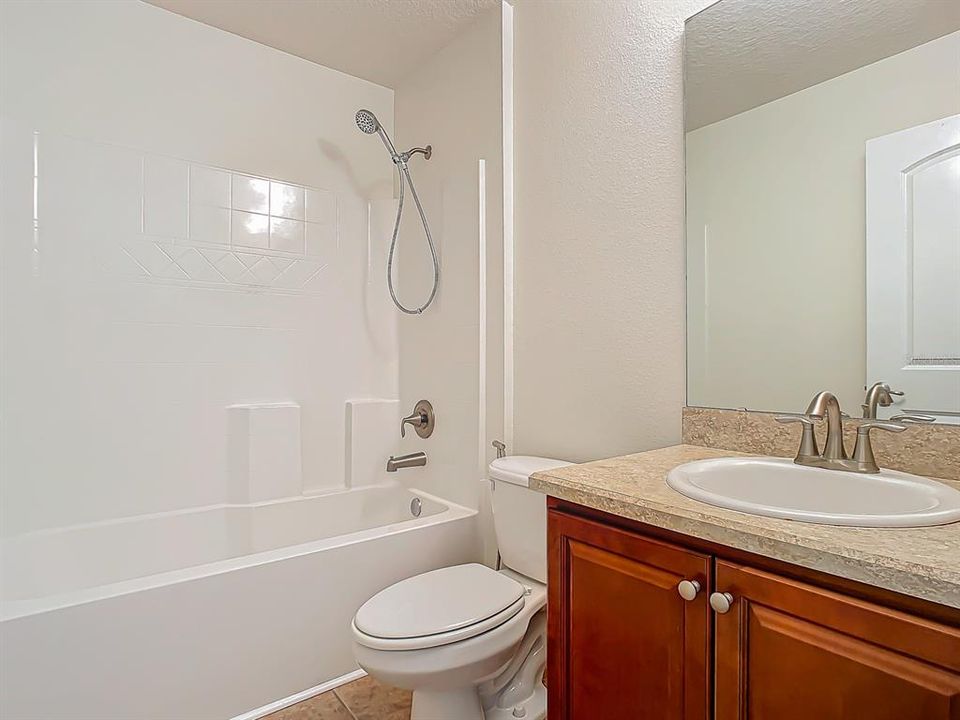 Bathroom #3 tub/shower combo and single sink with ample storage underneath