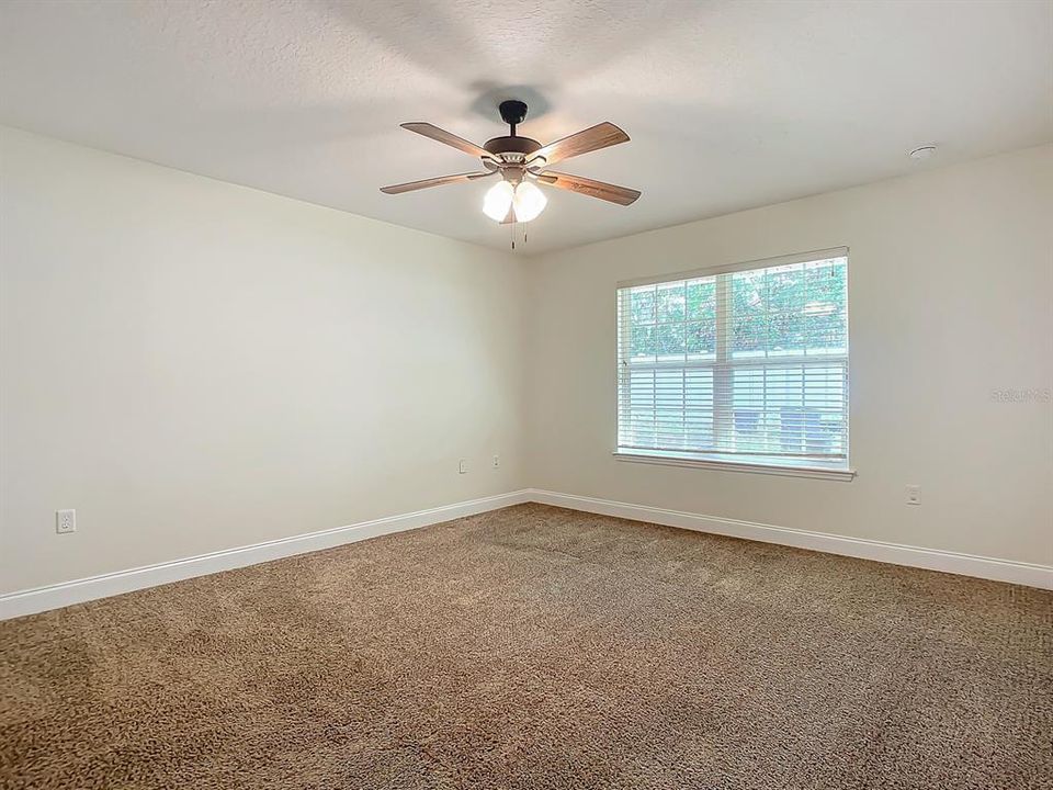 Master bedroom overlooks backyard