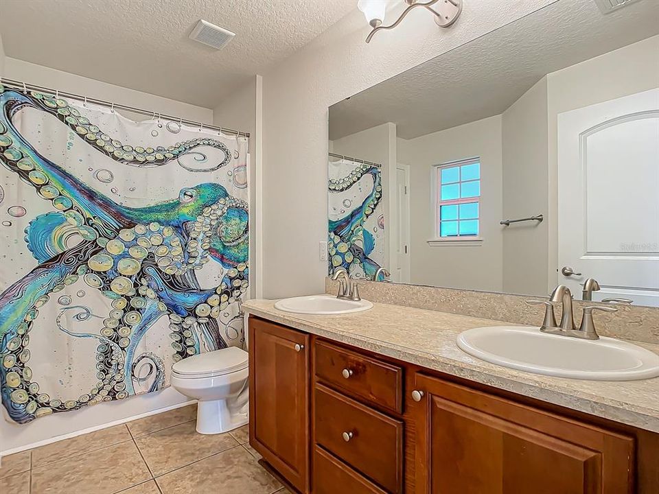 Bathroom #2 with double sink and bathtub/shower