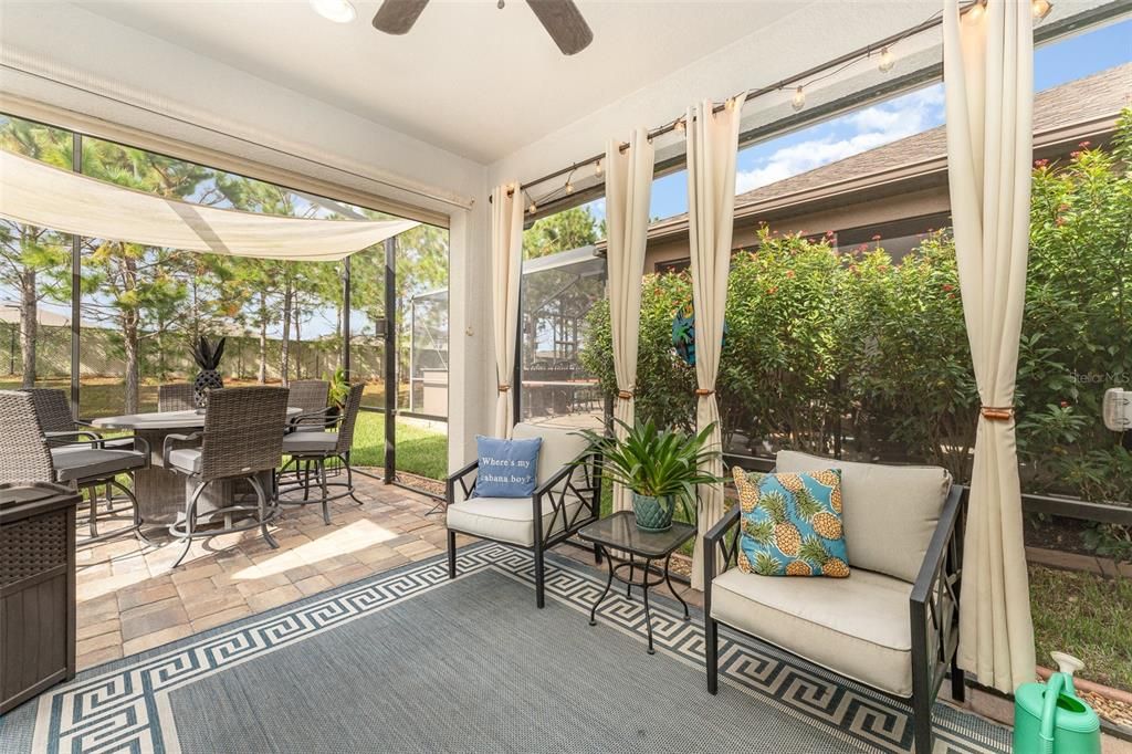 Covered screened lanai area with curtains