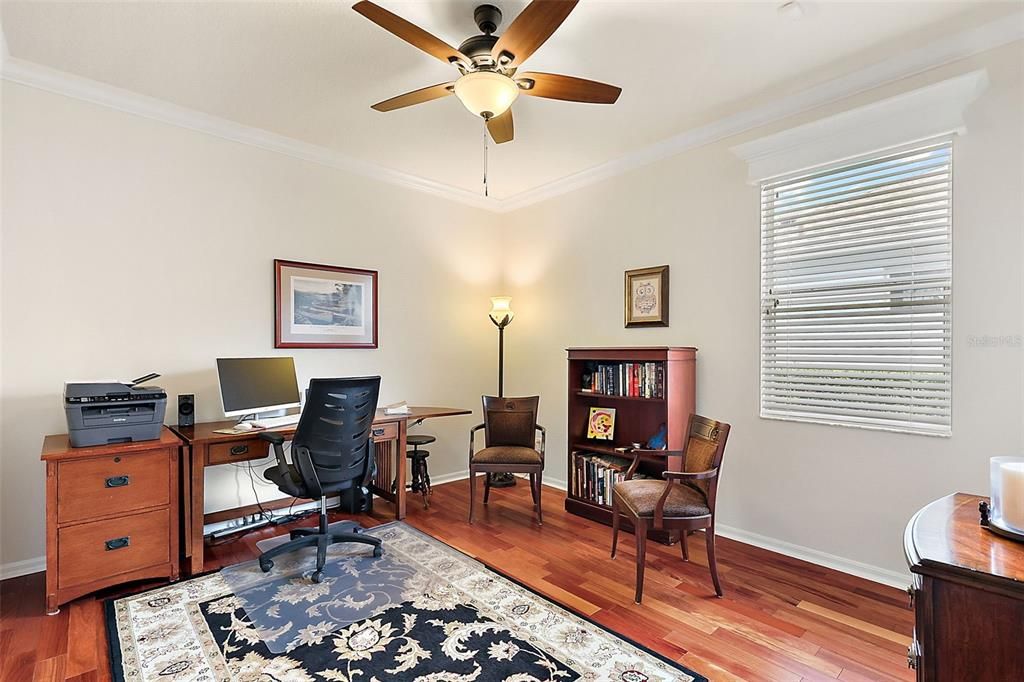 Bedroom 3 also has wood flooring and crown molding