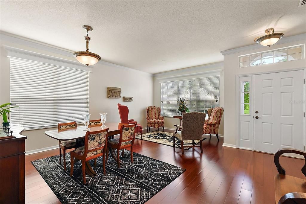 Foyer, formal living and dining; beautiful wood flooring throughout!