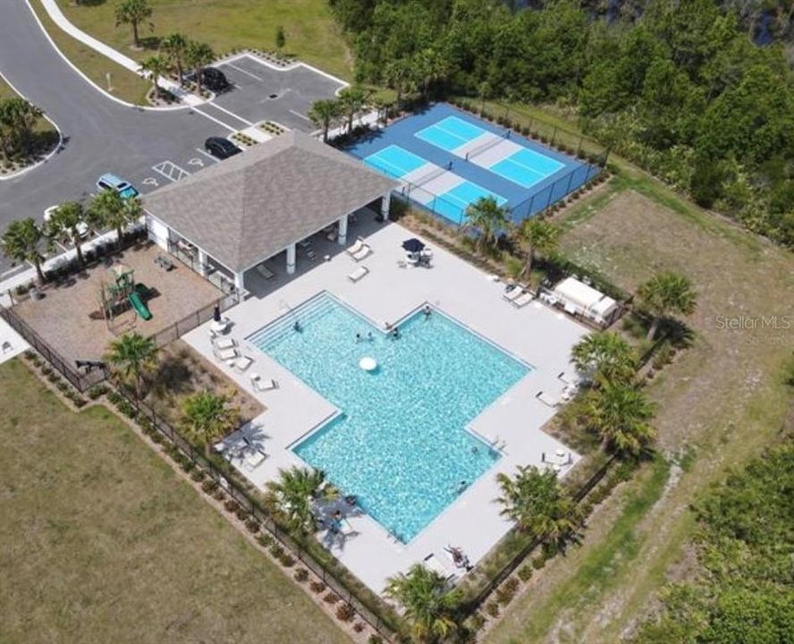 AMENITIES AREA WITH LARGE POOL AND PICKLEBALL COURTS.