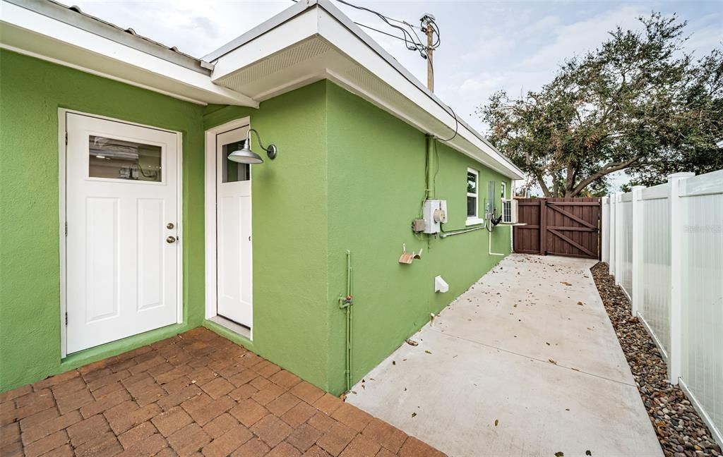 Just outside the laundry room is a poured concrete walkway to the front.