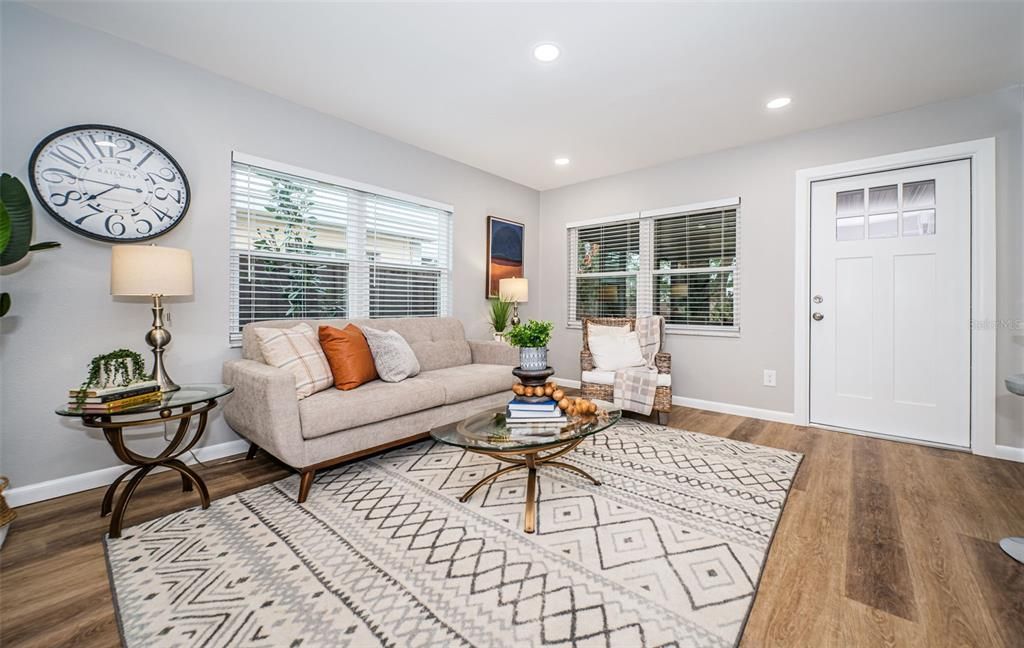 This loving area has tons of natural light with warm tone luxury vinyl floors.