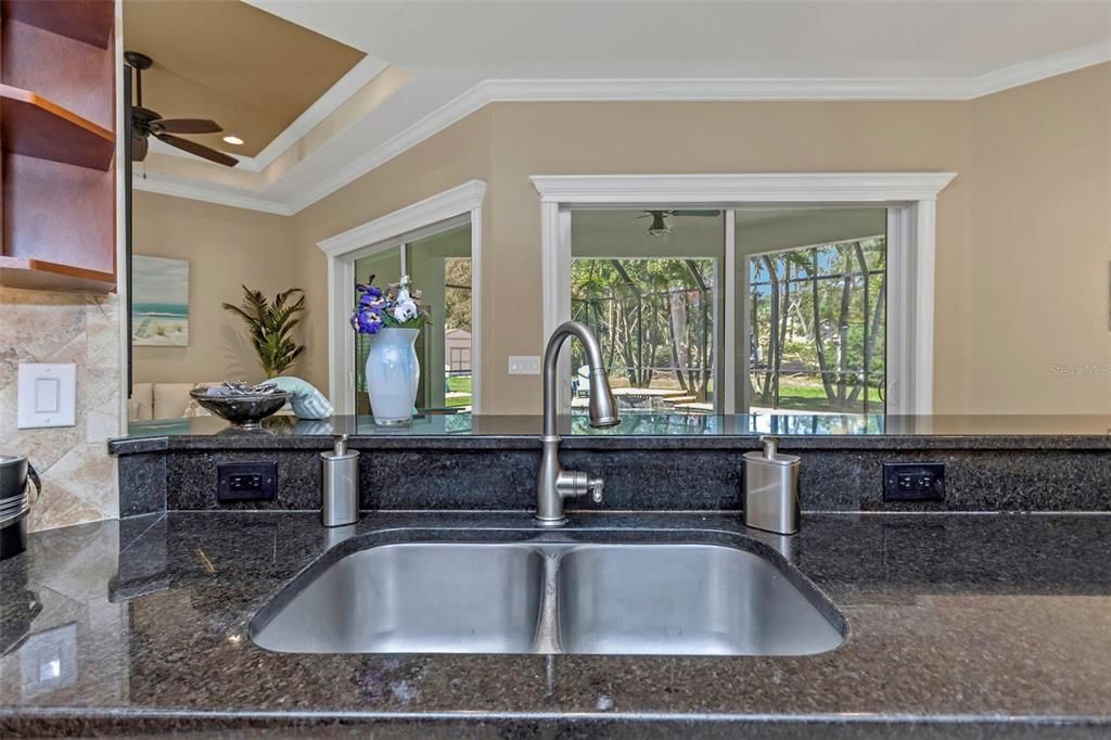 Kitchen sink looks out to pool & patio