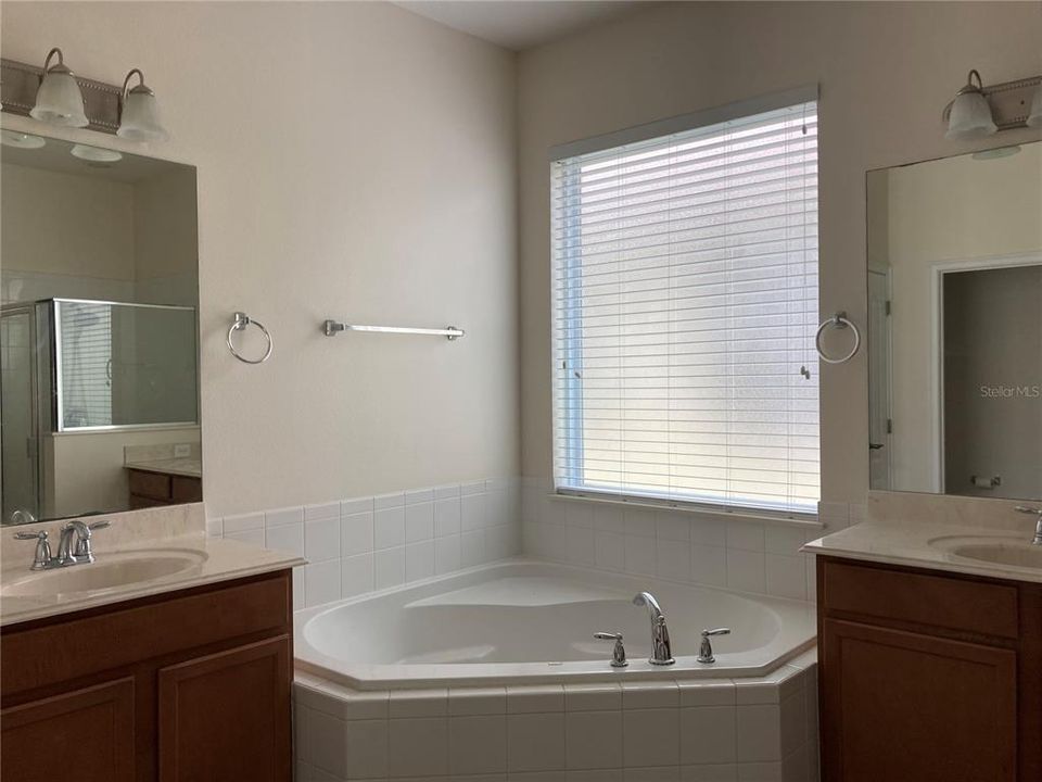 Large Owners Suite Bathroom with separate vanities and spa tub.