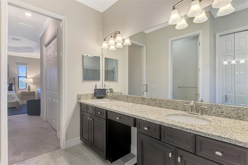 The ensuite bath has dual sinks and a vanity area for make-up