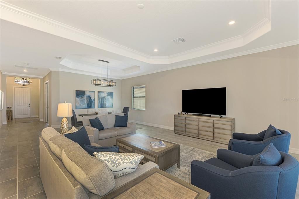 Living room looks out over lanai/water and golf course