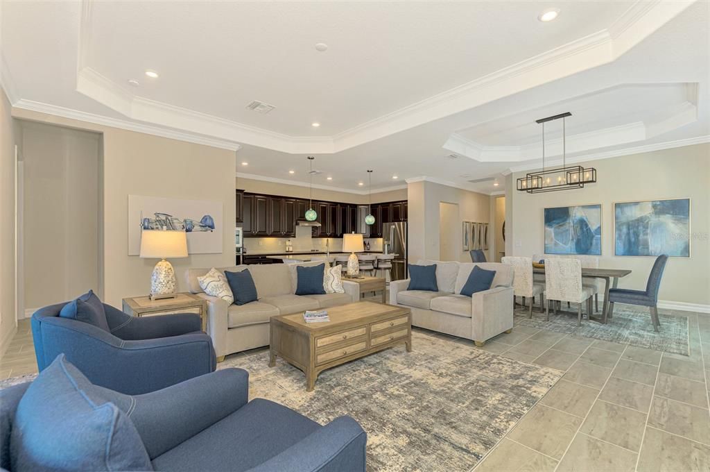 Living room looks out over lanai/water and golf course